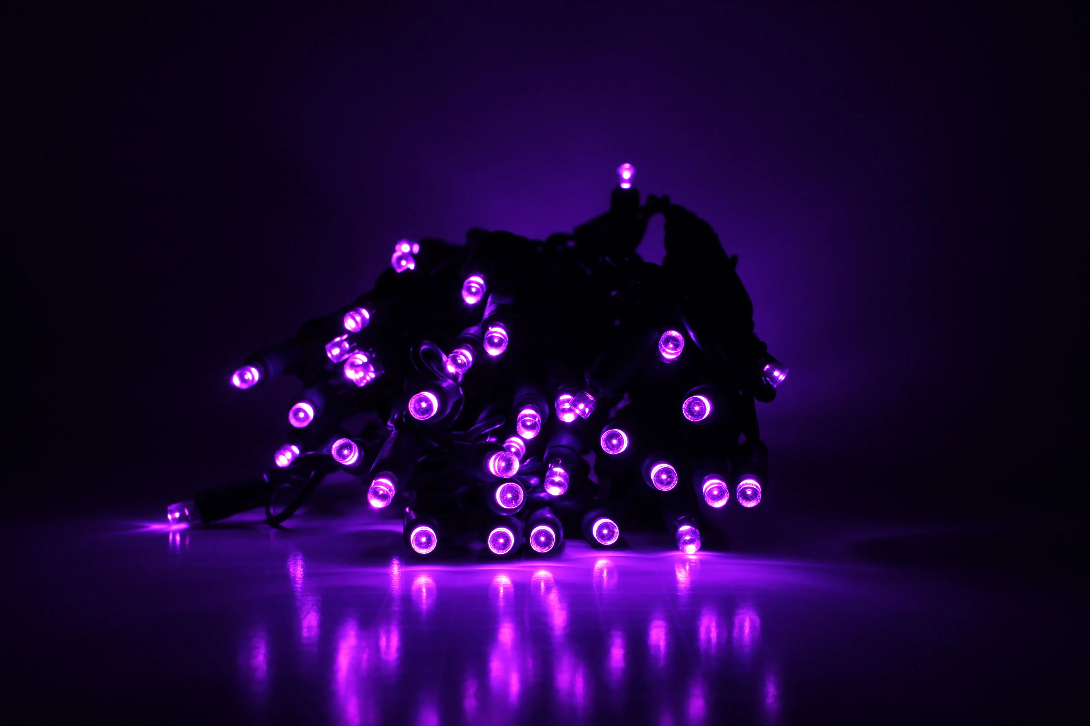 Outdoor LED Lighted Christmas Tree with Green Base and Orange and Purple Tree Lights